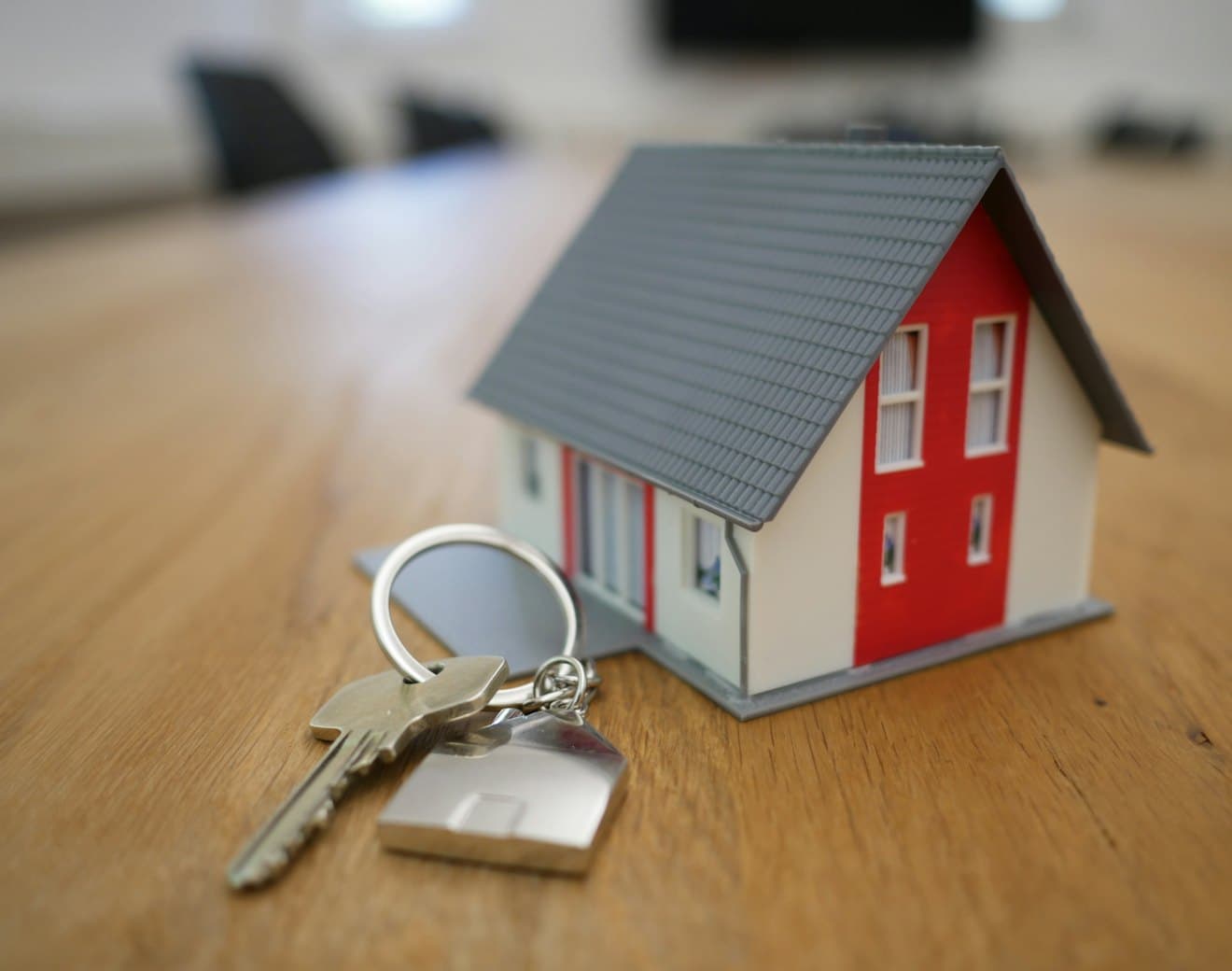 House keys resting beside a model home