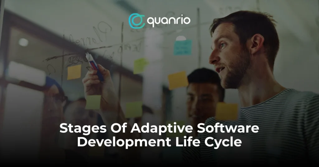 A person in a striped shirt writing on a glass wall with markers, with the text “Stages Of Adaptive Software Development Life Cycle” and the logo of “Quanrio” visible.