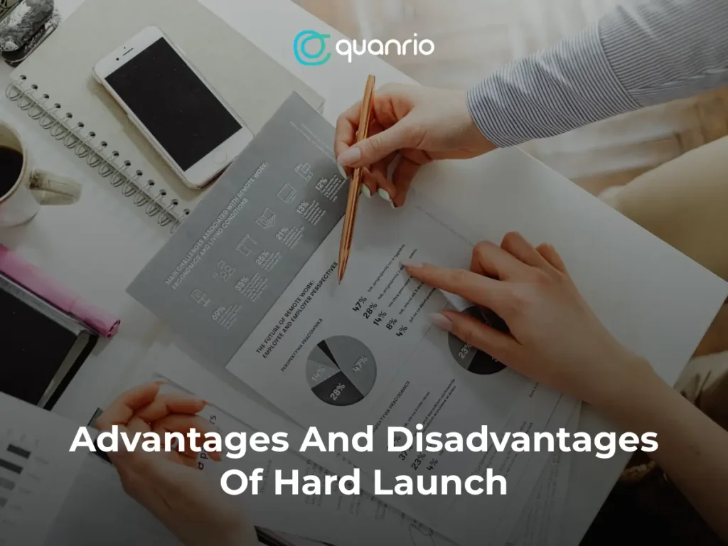 Two people reviewing documents with charts and graphs, discussing the advantages and disadvantages of a hard launch.