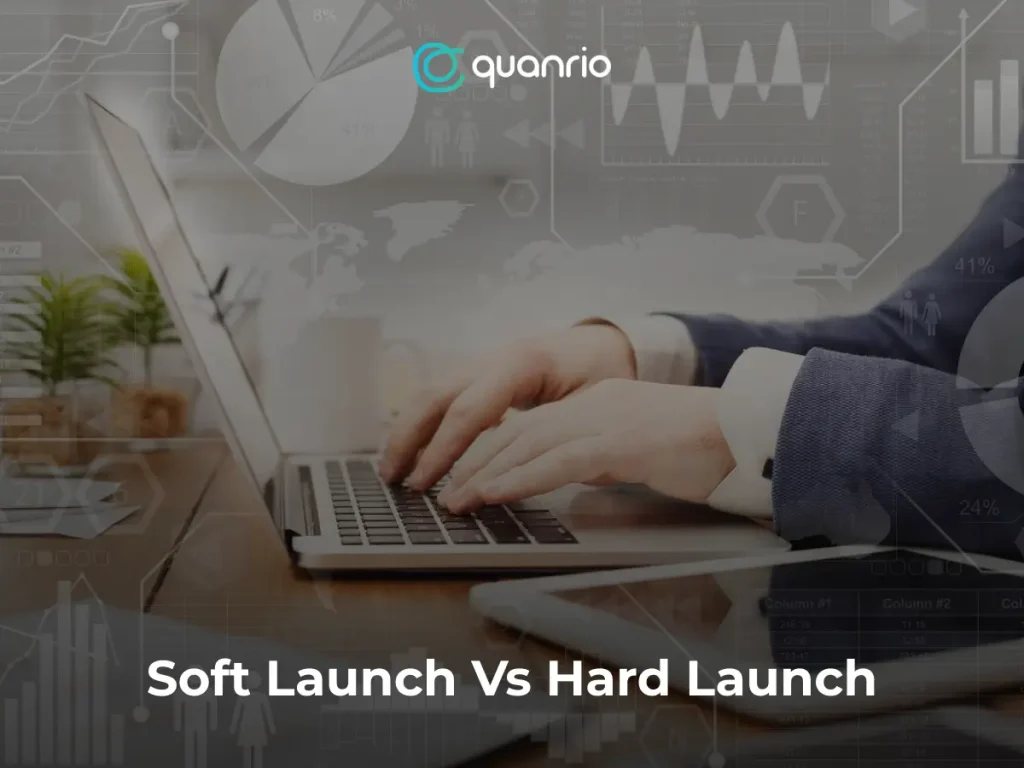 Person typing on a laptop with the text 'Soft Launch Vs Hard Launch' and the 'quonrio' logo overlaid on the image.