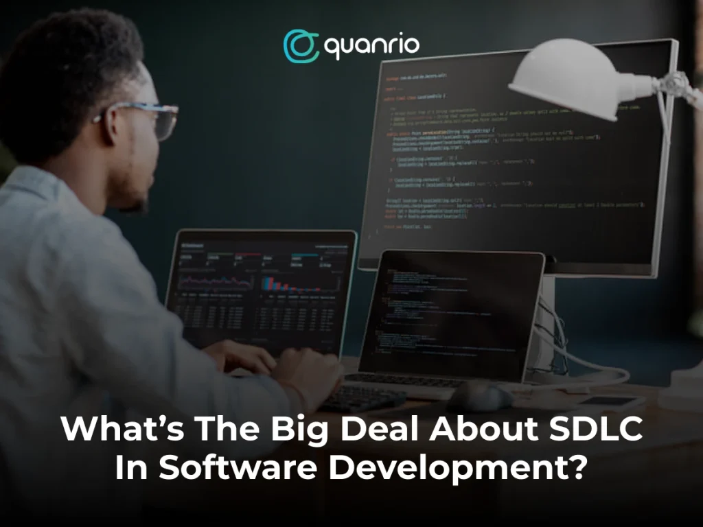 A person working at a desk with multiple screens displaying code and data visualizations, with the text "What's The Big Deal About SDLC In Software Development?" overlaying the image.